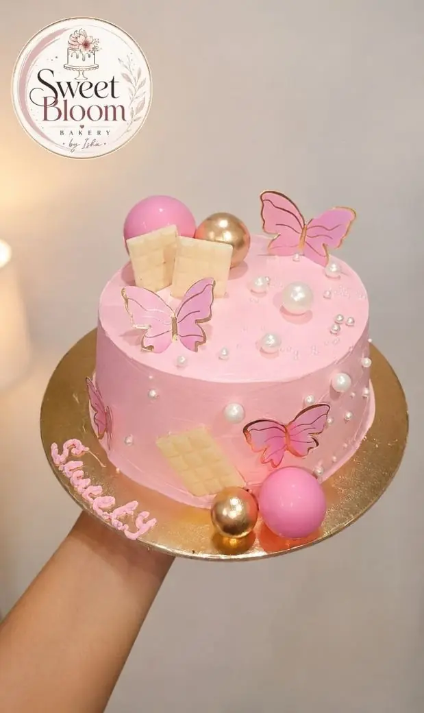 Pink butterfly theme cake with wafer butterflies and pearls — Asansol